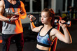 © Vadim - Fit woman is working out with trainer at the gym. Athlete and beauty doing workout. Healthy life sport concept.