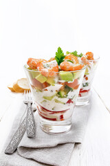 Wall Mural - Salad with shrimp and avocado in two glasses on napkin