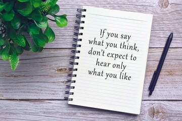 Motivational and inspirational quote on notebook with pen and plant