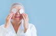 © Maria - Anti age concept. Happy natural woman seniora with a cotton pad cleanses the skin. Natural spa treatments at home, organic cosmetics. Healthcare and cosmetology, pensioner, mature people, new senior