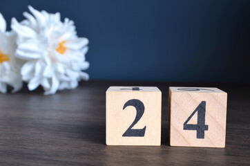 Wall Mural - Number 24, rating, award, Empty cover design in natural concept with a number cube and peony flower on wooden table for a background.