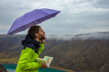 The guy imagines that he is blowing clouds out of his mouth. Rainy spring or autumn day. Conceptual image