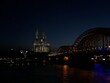 Illuminated Bridge Over River In City At Night