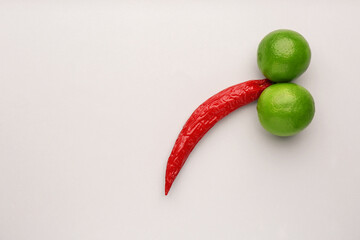 Wall Mural - Chili pepper and limes symbolizing male sexual organ on white background, flat lay with space for text. Potency problem