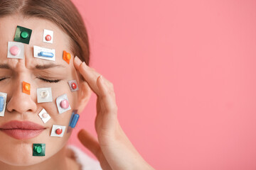 Sticker - Ill young woman with different pills on her face against color background