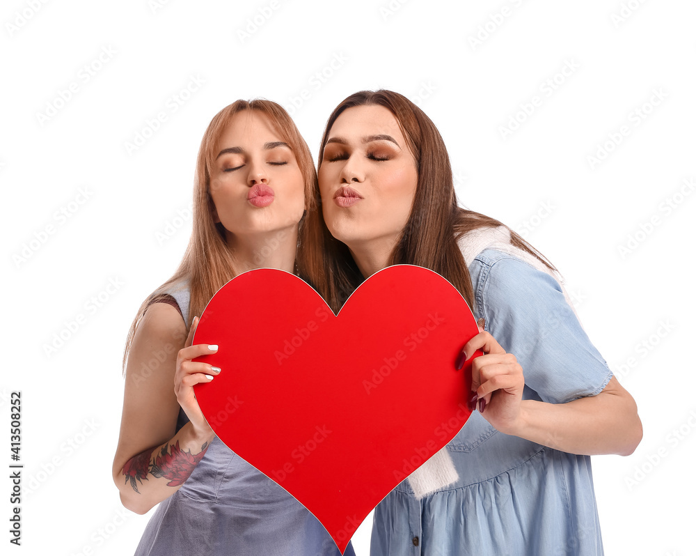 Young transgender couple with red heart on white background. Valentine's Day celebration