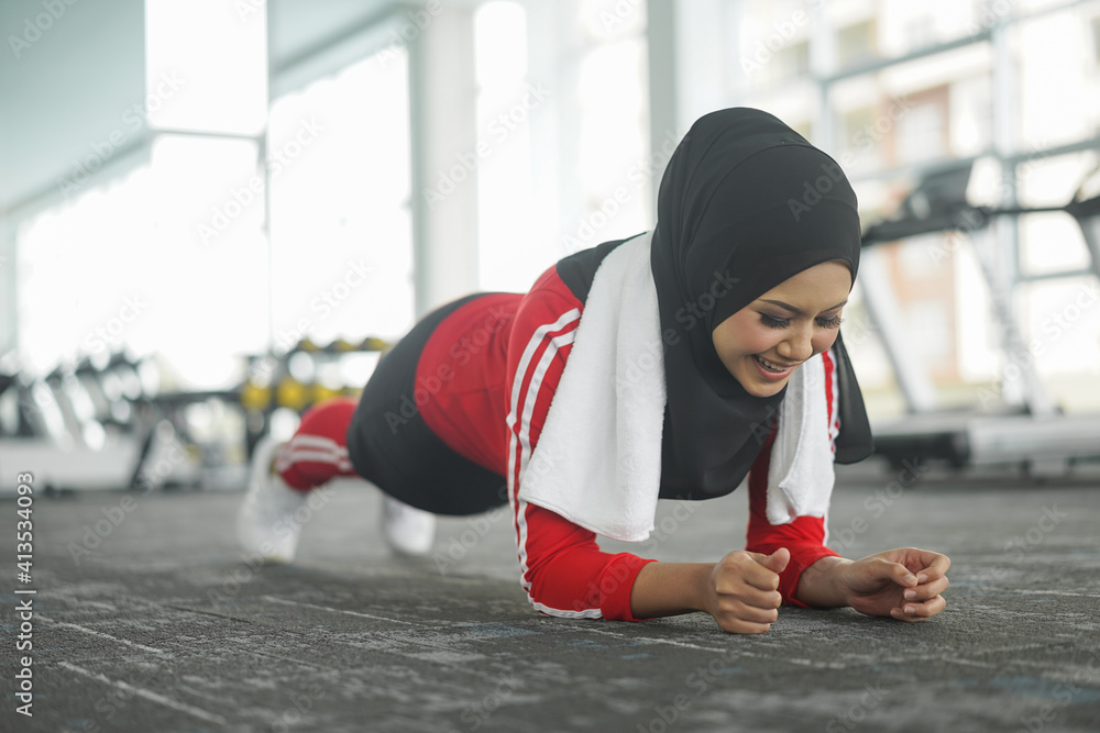 Portrait of attractive young Muslim woman workout in gym healthy ...