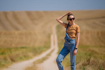 girl on the road with wheat field