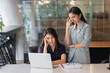 © Songsak C - Portraits of two businesswomen consulting on their project while working in office room.