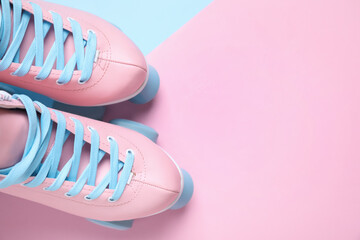 Wall Mural - pair of stylish quad roller skates on color background, flat lay. space for text