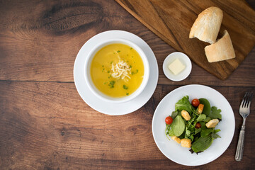 Wall Mural - Chicken Noodle Soup and Salad on a Wooden Table