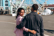 © dimadasha - Evening walk of a beautiful young couple around the city. A loving couple travels.