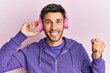 © Krakenimages.com - Young handsome man listening to music using headphones screaming proud, celebrating victory and success very excited with raised arm