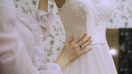 Poster - bride's hands on wedding dress in the morning