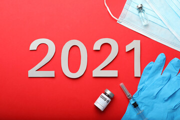 Wall Mural - Flat lay composition with coronavirus vaccine and number 2021 on red background