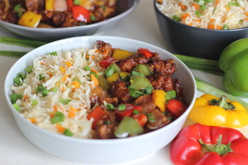 Wall Mural - Vegetable Carrot Fried Rice with Indian spices served along with chilly chicken.