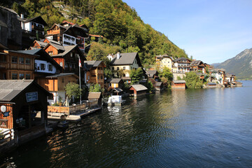 Wall Mural - Reflecting lake amid the mountains with the coastline buildings