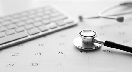 Annual checkup concept. Stethoscope on the calendar with soft-focus and over light in the background