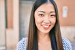 © Krakenimages.com - Young chinese woman smiling happy walking at street of city.