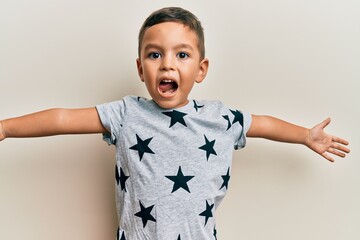 Wall Mural - Adorable latin toddler wearing casual clothes looking at the camera smiling with open arms for hug. cheerful expression embracing happiness.