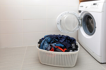 washing machine and clothes in plastic basket