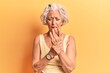 © Krakenimages.com - Senior grey-haired woman wearing casual clothes suffering pain on hands and fingers, arthritis inflammation