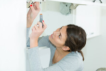 Woman Using Screw Driver For Diy Work