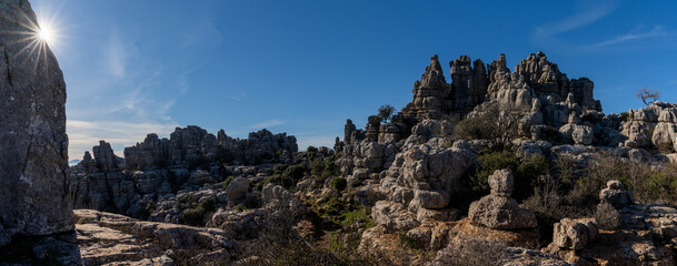 panorama view of the El Torcal Nature Reserve in Andalusia with ist strange karst rock formations with a sun star