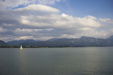 Sticker - Sailboat in the lake with mountains in the background