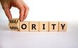 Minority or majority symbol. Businessman turns a cube and changes the word 'minority' to 'majority'. Beautiful white background. Minority or majority and business concept. Copy space.