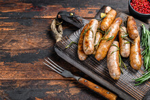 Grilling Bavarian Sausages On A Cutting Board. Dark Wooden Background. Top View. Copy Space