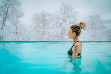 Beautiful Blue-eyed Androgynous Girl With Dreadlocks And Tattoos In A Warm Pool 