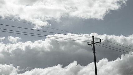 Cloudy sky and electricity pole