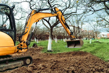 Wall Mural - Home landscaping using excavcator and bulldozer. Landscaping the garden terrain