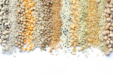 Collection of dry organic cereal and grain seed stripe consisted of black eye pea, pearl barley, soybeean, lentil, flax seed, sesame, melon and rice seeds on white background