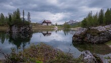 Motion-lapse Of Clouds Reflecting On Federa Lake And Palmieri Refuge. Italy