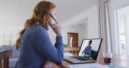 Poster - Caucasian woman using laptop and phone headset on video call with male colleague