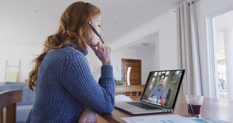 Poster - Caucasian woman using laptop and phone headset on video call with male colleague