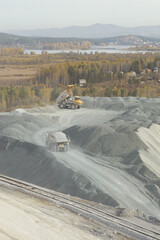 Wall Mural - Mining trucks transport crushed stone at a mining enterprise.