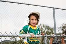 Portrait Of Cheerful Boy In Baseball Uniform Against Clear Sky