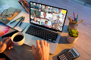 Sticker - Mid section of teacher having a video conference with multiple students on laptop at school