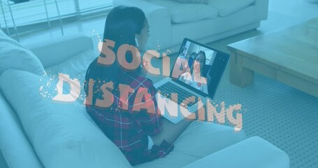 Sticker - Animation of social distancing text over woman using laptop on video call