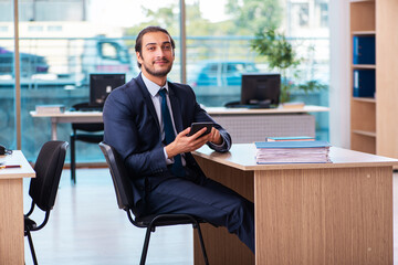 Young male bookkeeper working in the office