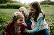 © Cavan Images - Cheerful sisters playing on field at park