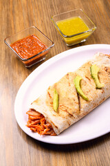 Wall Mural - Mexican burrito with copy space. Mexican food on wooden table.