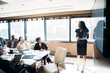 © Cavan Images - Businesswoman giving presentation in meeting at board room