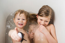 Portrait Of Happy Brother With Sister Bathing In Bathtub At Home