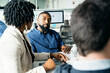 © Cavan Images - Businessman looking at female business colleague while discussing in office