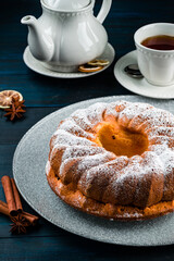 Wall Mural - Bundt cake with sugar powder with copy space. Homemade ring cake with icing sugar on wooden table, closeup, rustic style.