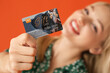 © Pixel-Shot - Beautiful young woman with gift card on color background